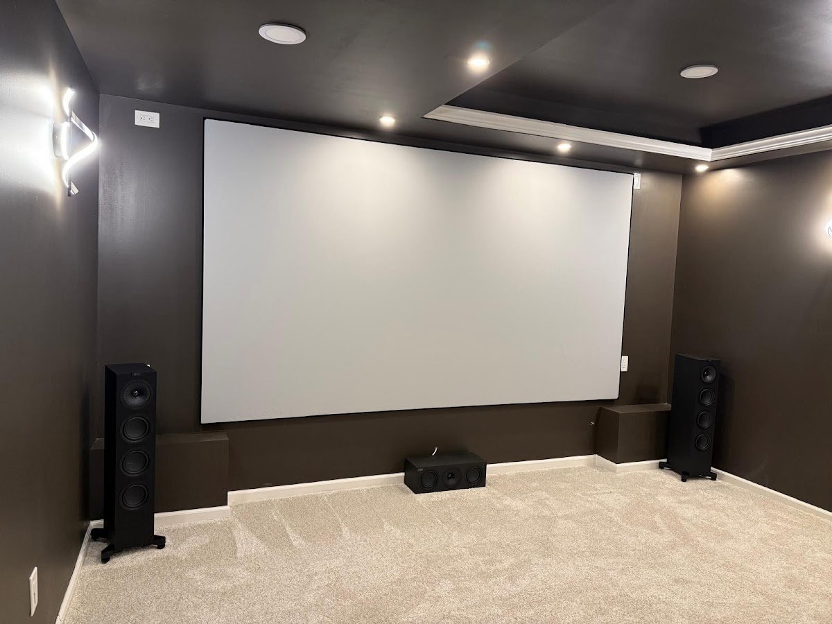 Dedicated home theater room with projector screen and surround speakers installed by Rtechwork