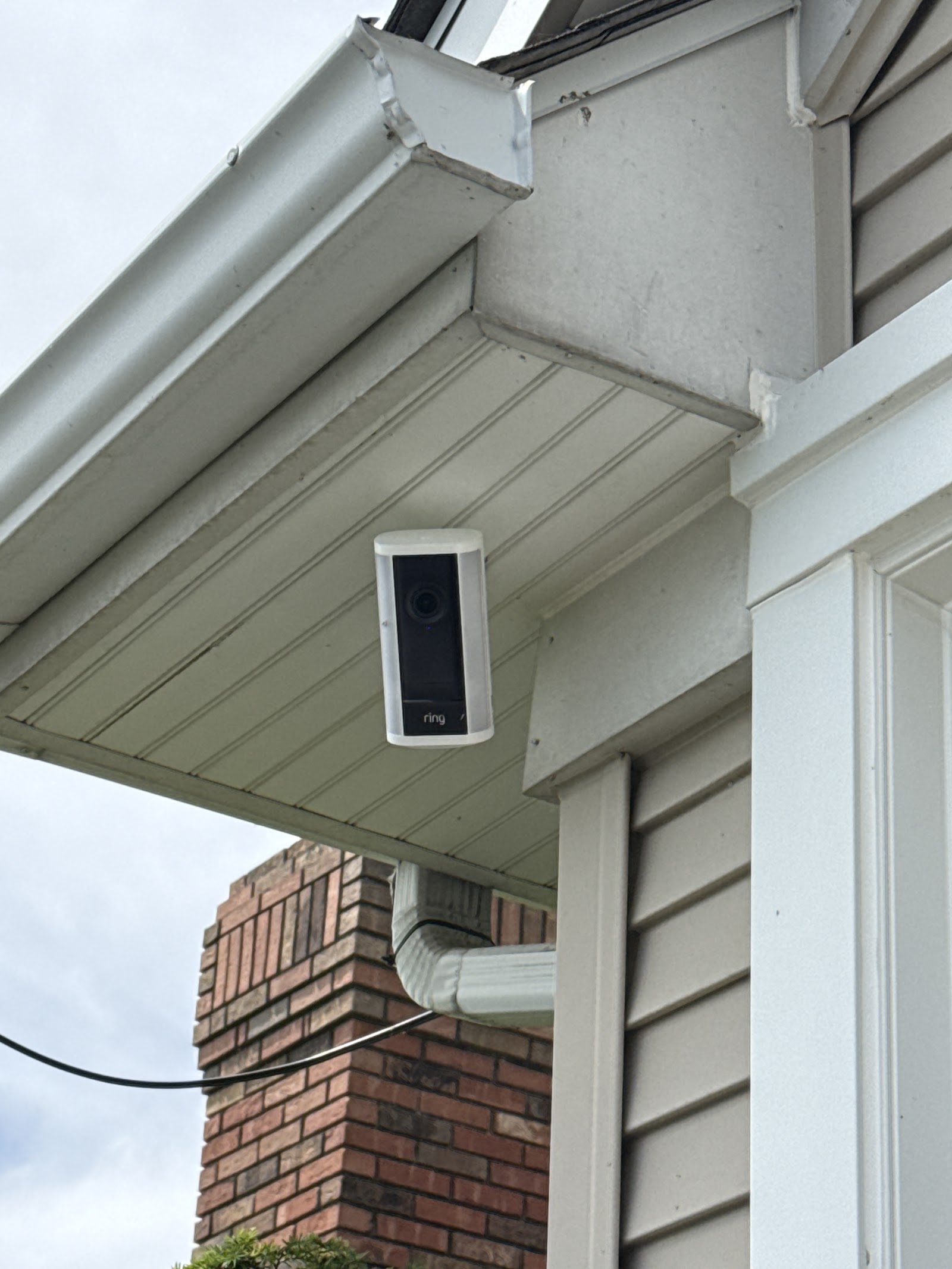 Exterior security camera mounted under the eave of a Metro Detroit area home by Rtechwork