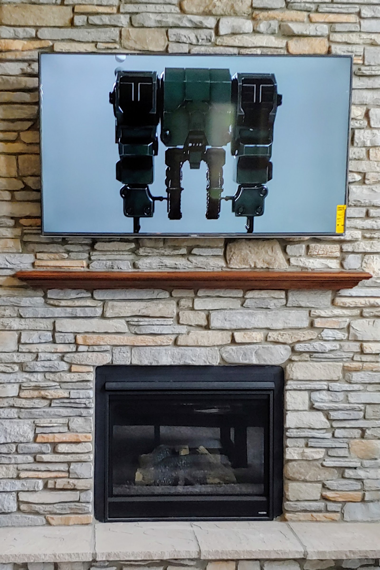 Structured cabling and mounting hardware installed behind a wall-mounted TV by Rtechwork