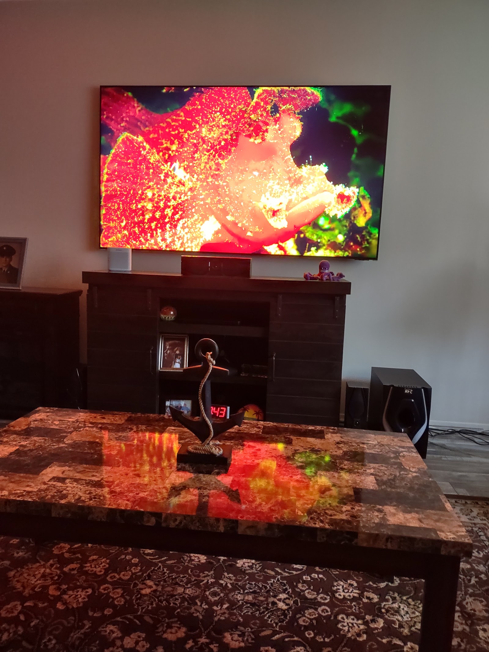Wall-mounted TV displaying artwork above a media console, installed by Rtechwork in Metro Detroit